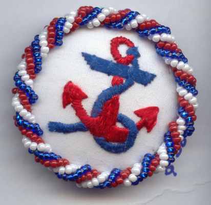 embroidered anchor in red, white and blue, with beaded border