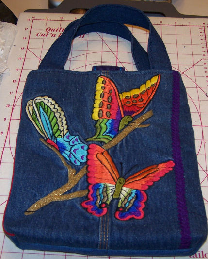 denim bag, machine and hand embroidered, back view.