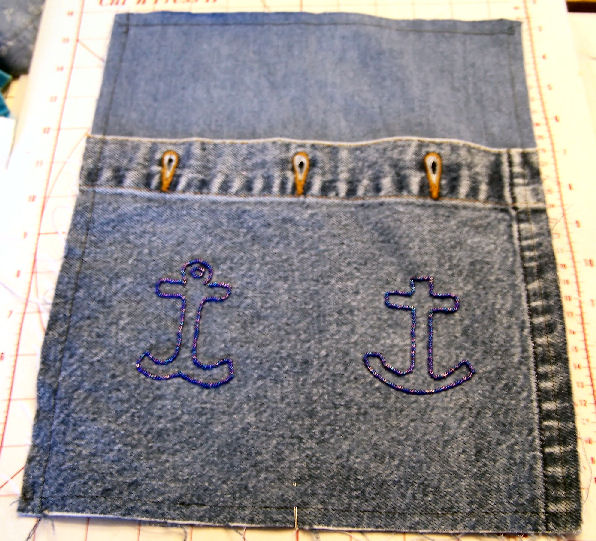 Denim purse with beaded crosses, lined, with zipper.  This side has beaded anchor crosses