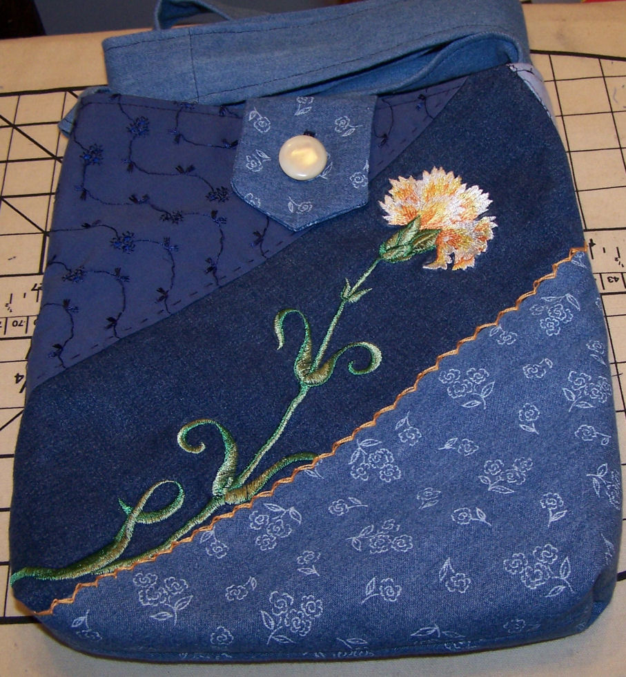 Denim bag with machine embroidery and pearl buttons